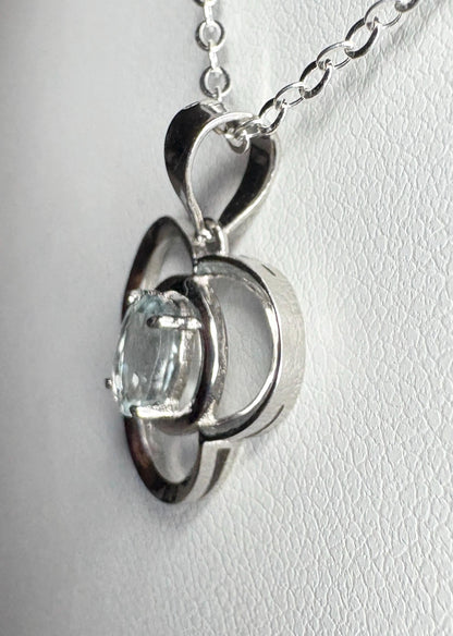 Sterling silver pendant necklace with a light blue oval tourmaline in a clover design.