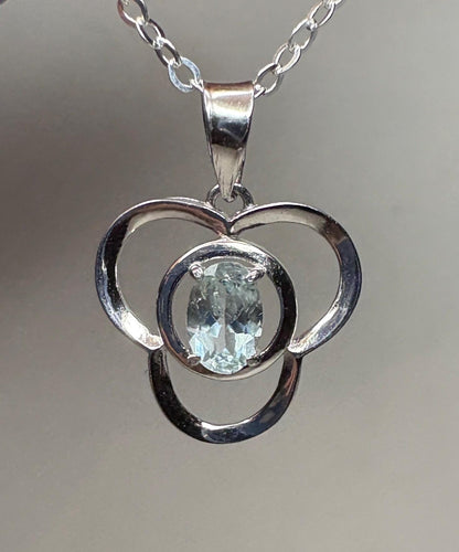 Sterling silver pendant necklace with a light blue oval tourmaline in a clover design.