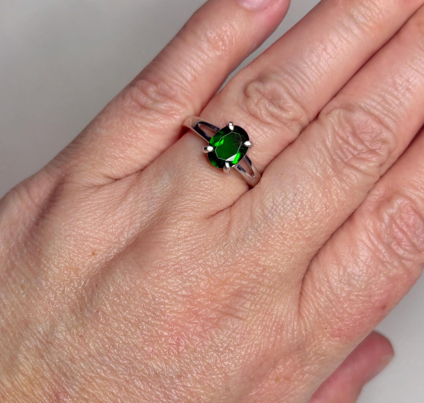 Sterling silver ring with an oval chrome diopside gemstone.