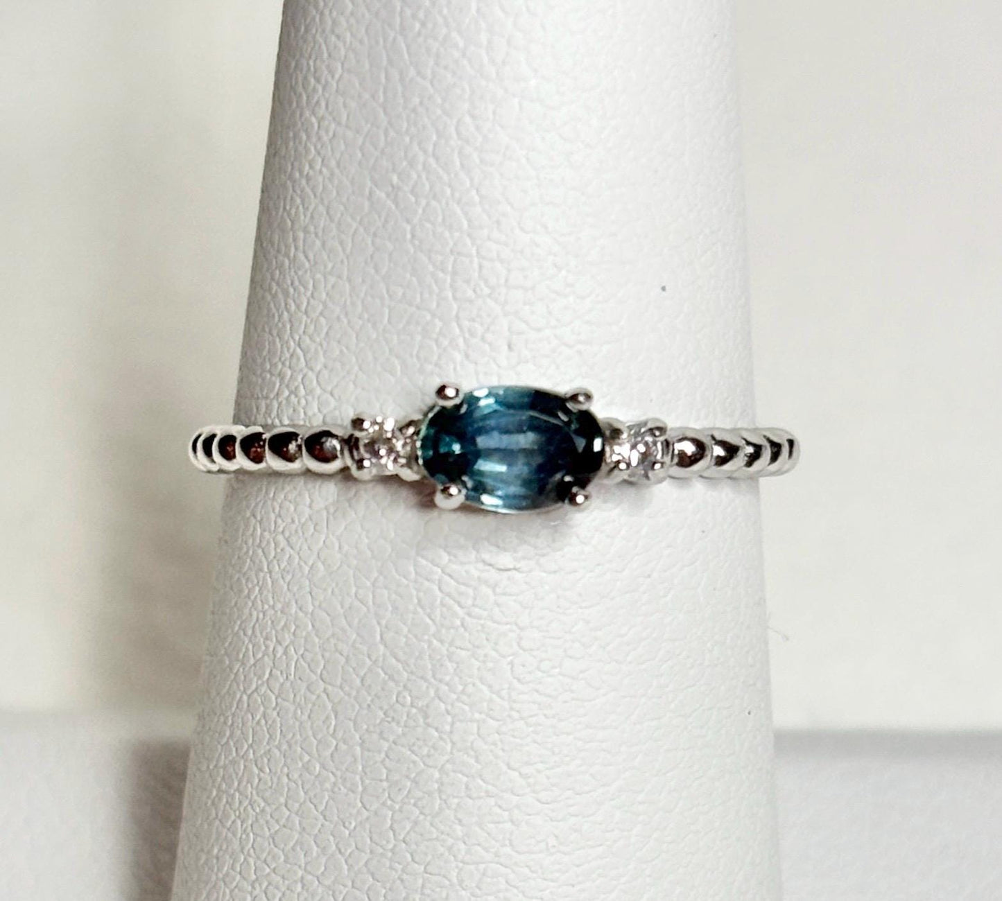 Sterling silver ring with oval Montana sapphire and diamonds on a beaded band.
