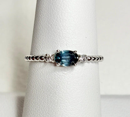Sterling silver ring with oval Montana sapphire and diamonds on a beaded band.