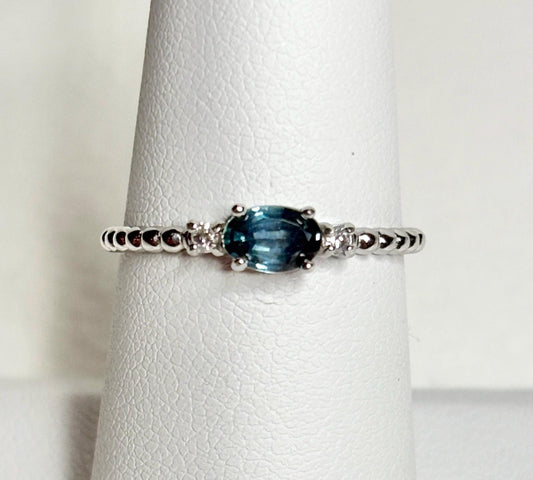 Sterling silver ring with oval Montana sapphire and diamonds on a beaded band.