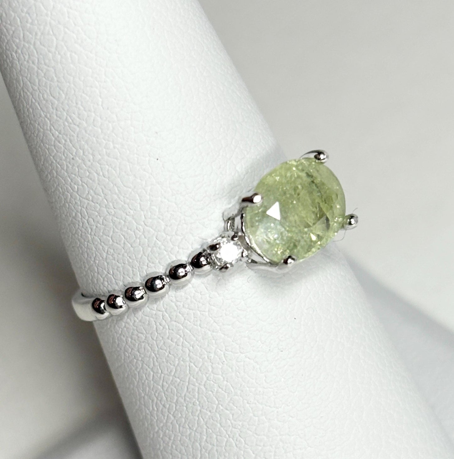 Sterling silver ring with a green cuprian tourmaline and two diamonds.