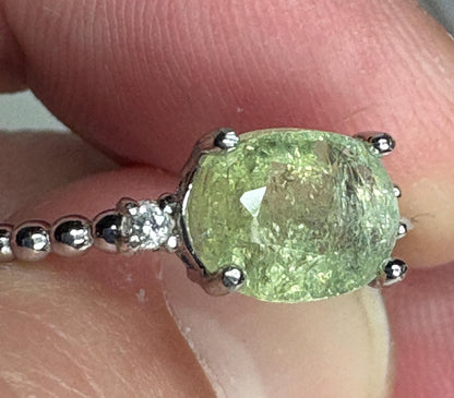 Sterling silver ring with a green cuprian tourmaline and diamonds.