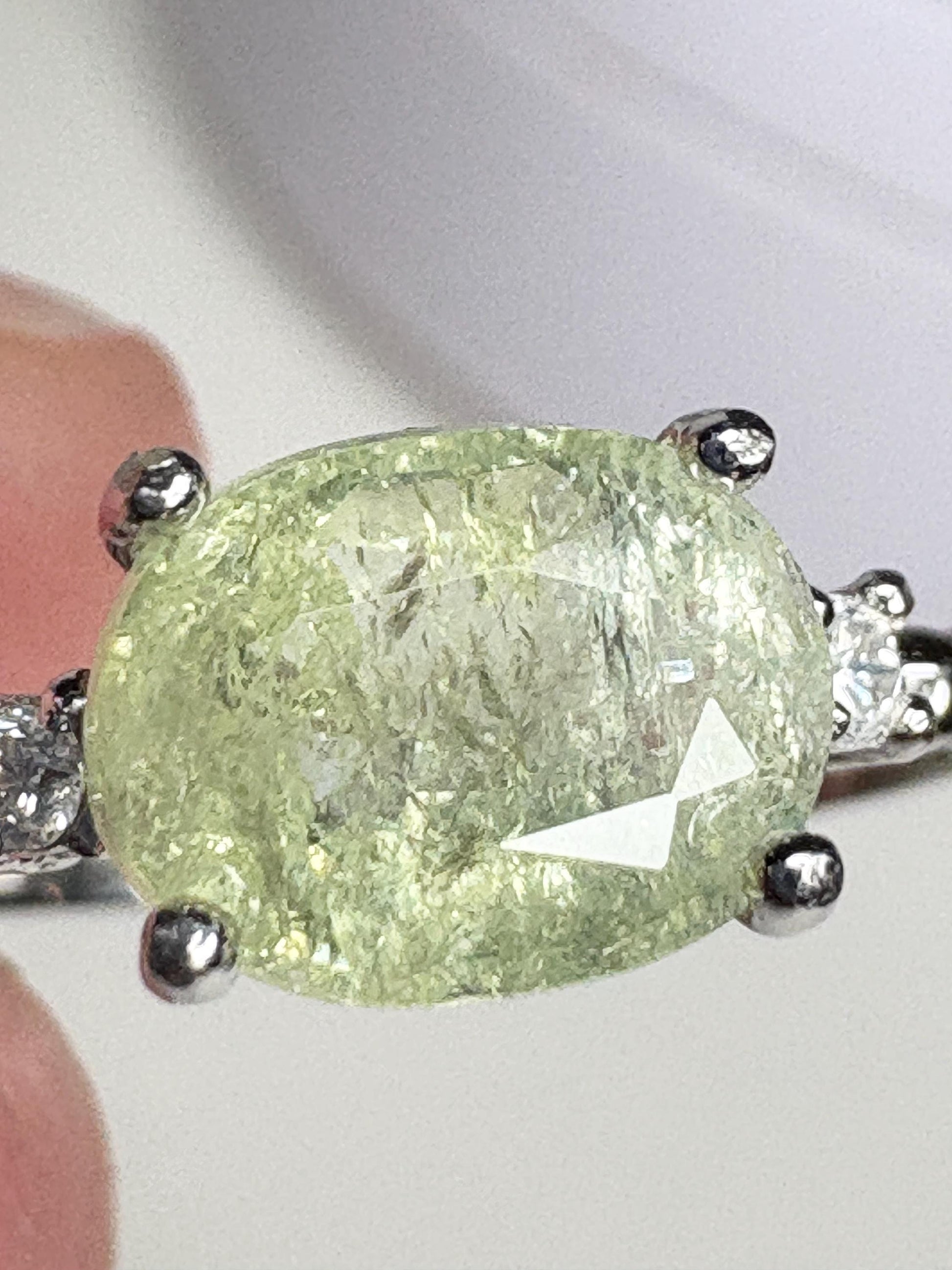 Sterling silver ring with a green cuprian tourmaline and diamonds.