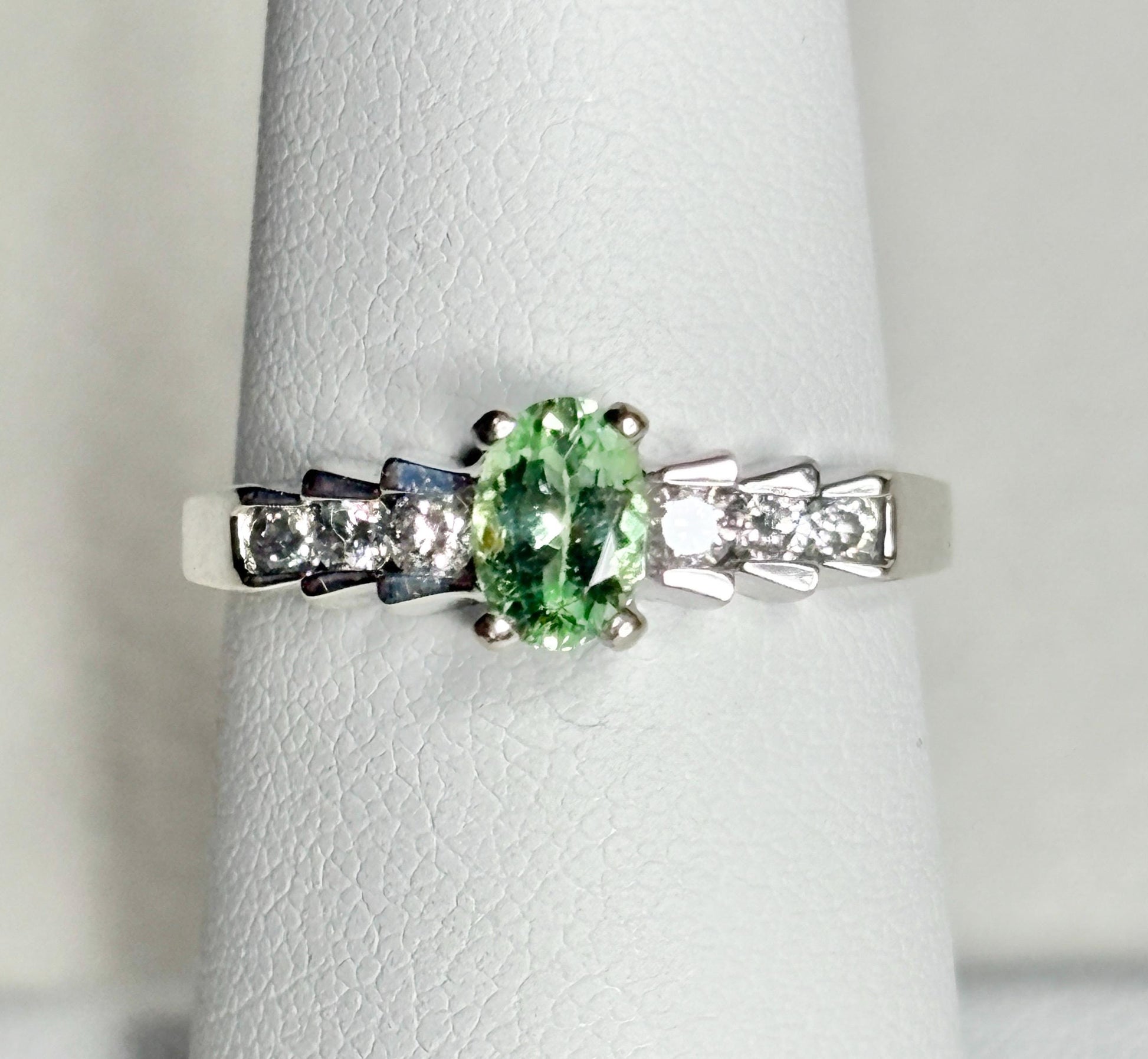 Oval green tourmaline and diamond ring in 14k white gold.
