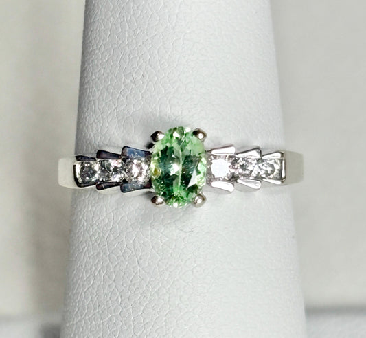 Oval green tourmaline and diamond ring in 14k white gold.