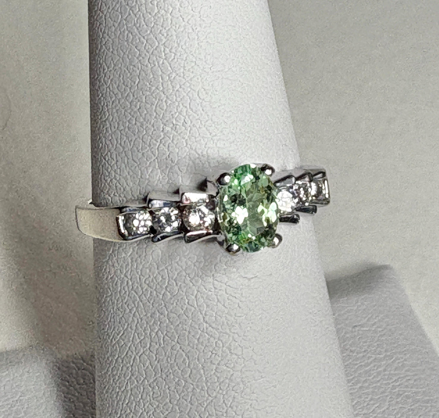14k white gold ring with oval green tourmaline and diamonds.