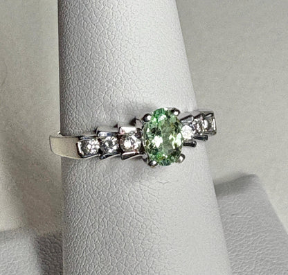 14k white gold ring with oval green tourmaline and diamonds.