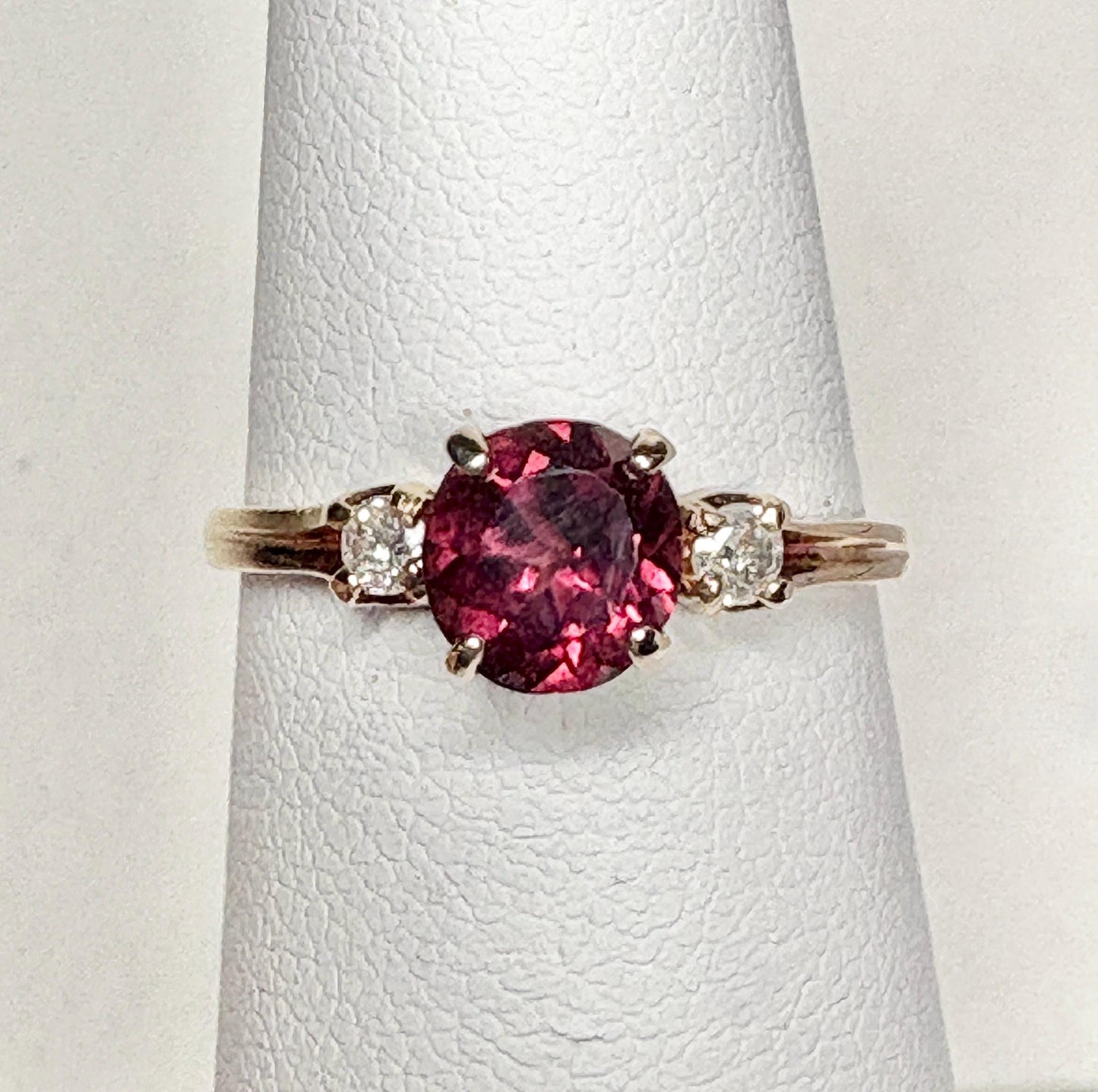Vintage 10k gold ring with a merlot garnet and two diamonds.