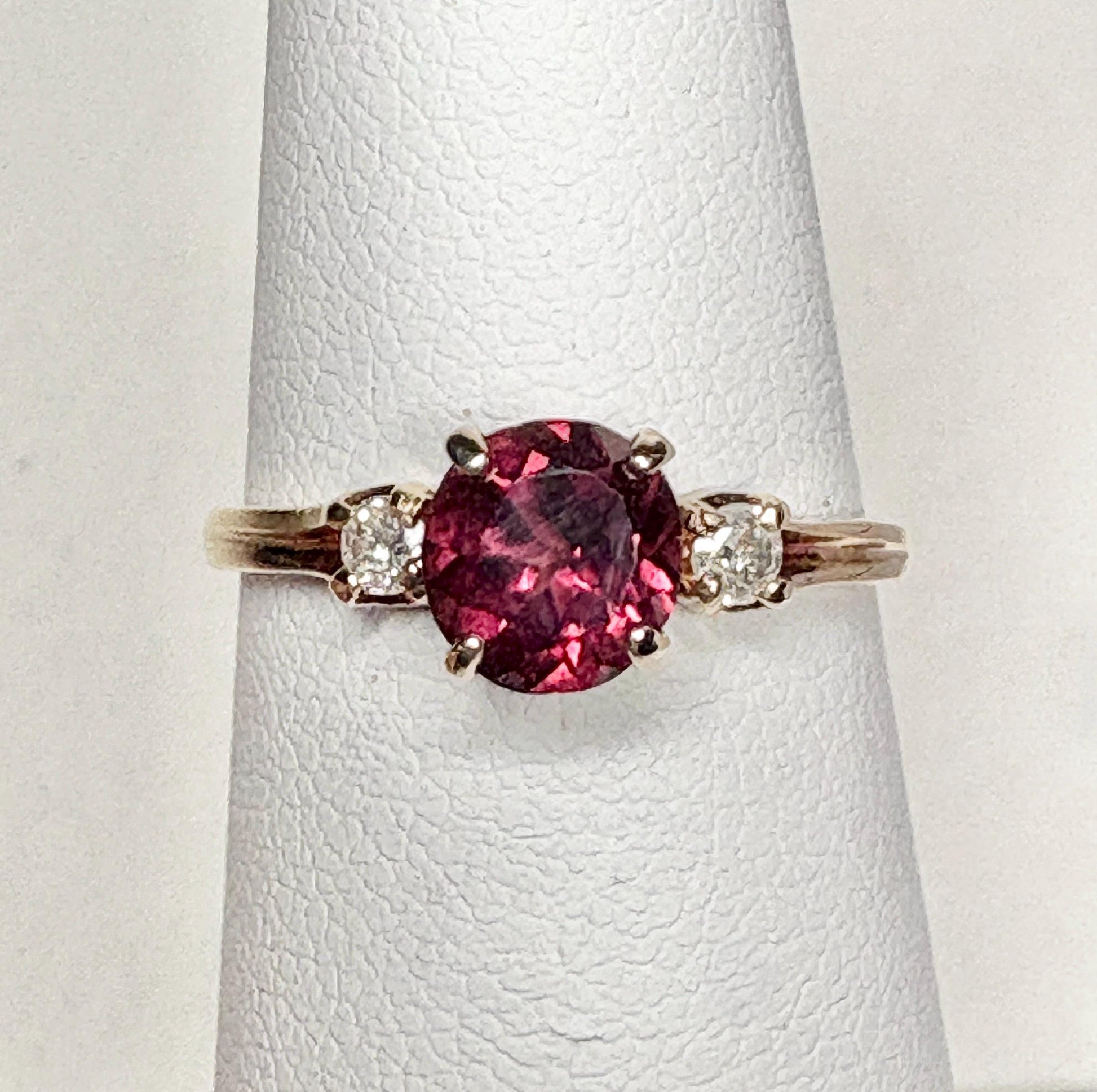 Vintage 10k gold ring with a merlot garnet and two diamonds.