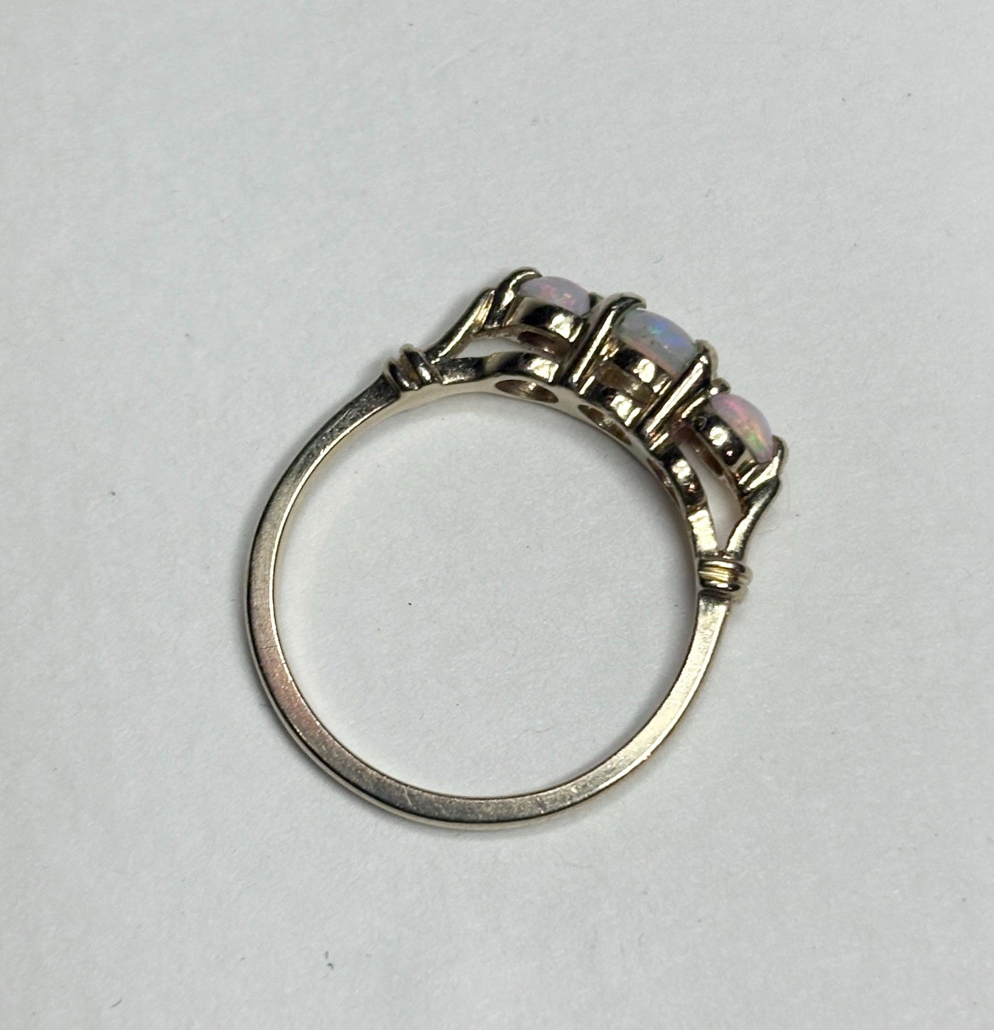 A 14k gold ring with three opals.