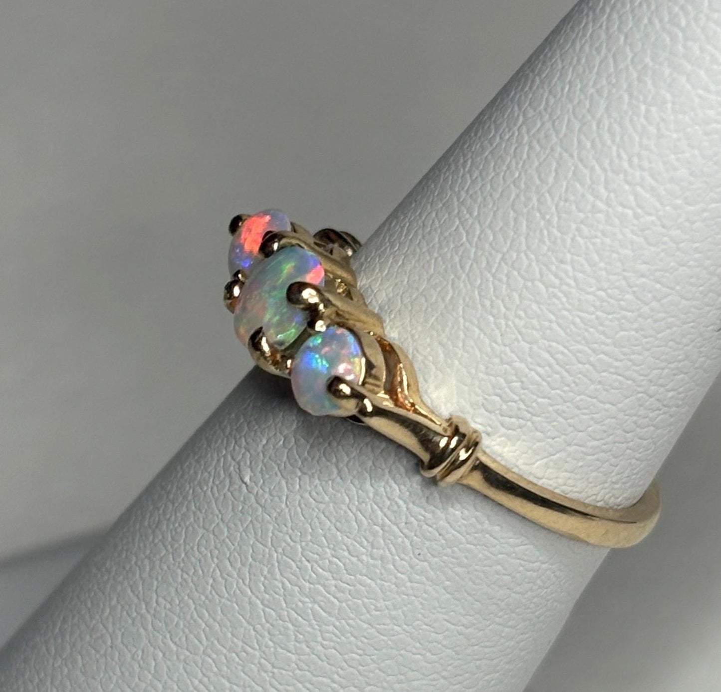 A 14k gold ring with three Australian opals.