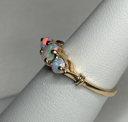 A 14k gold ring with three Australian opals.