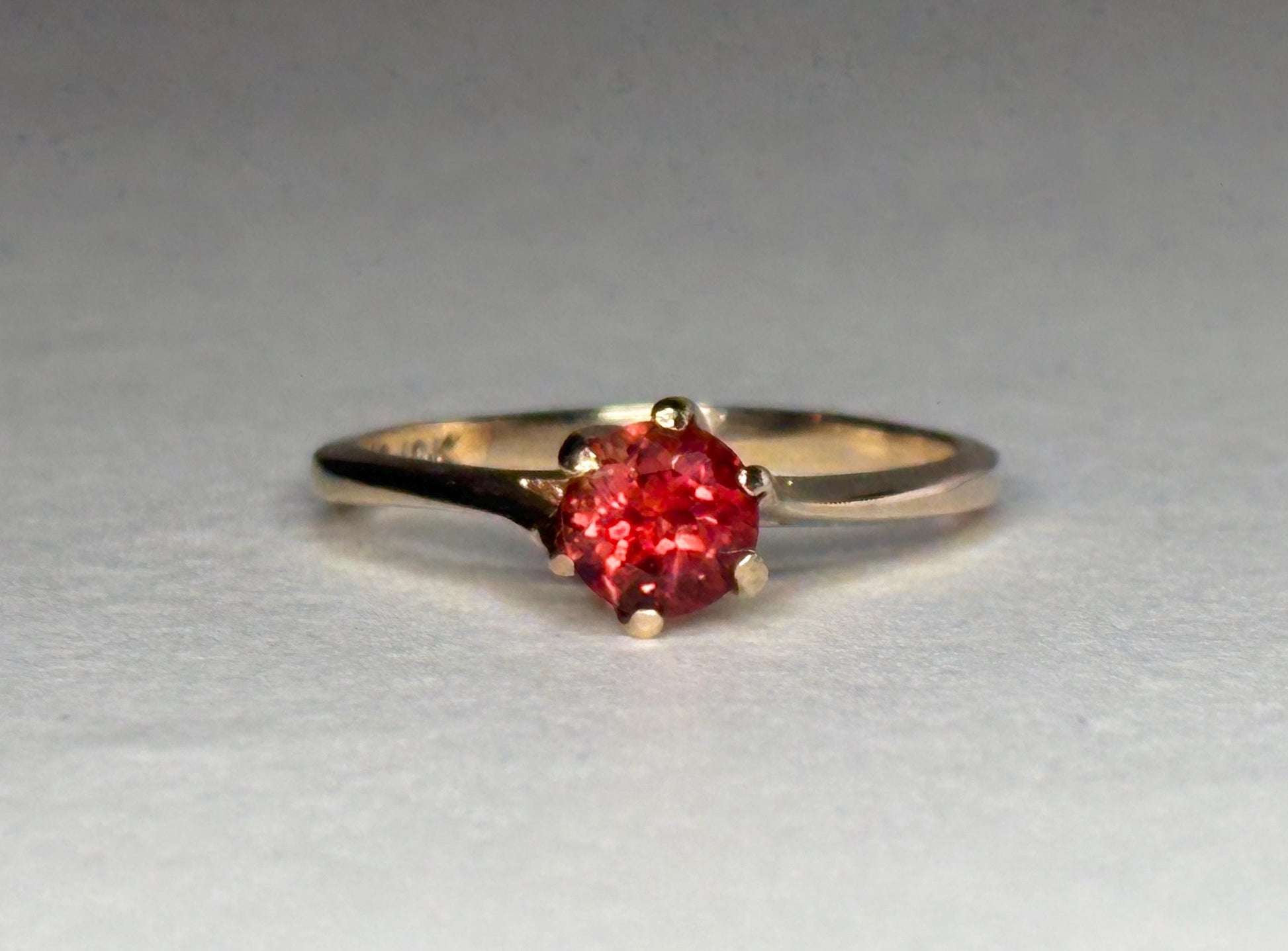 Red Oregon sunstone solitaire ring in 10k gold.
