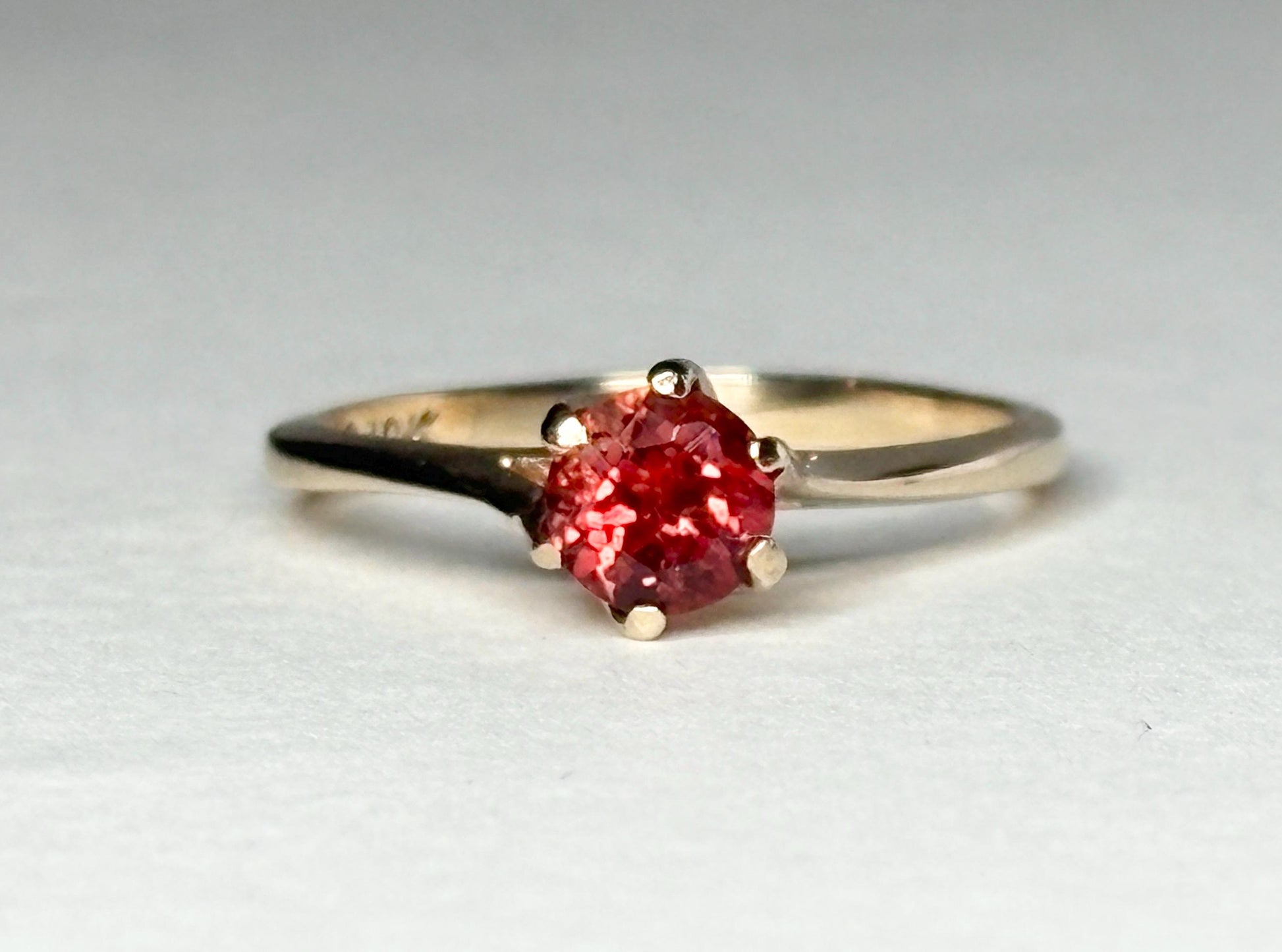 A 10k gold ring with a red Oregon sunstone.