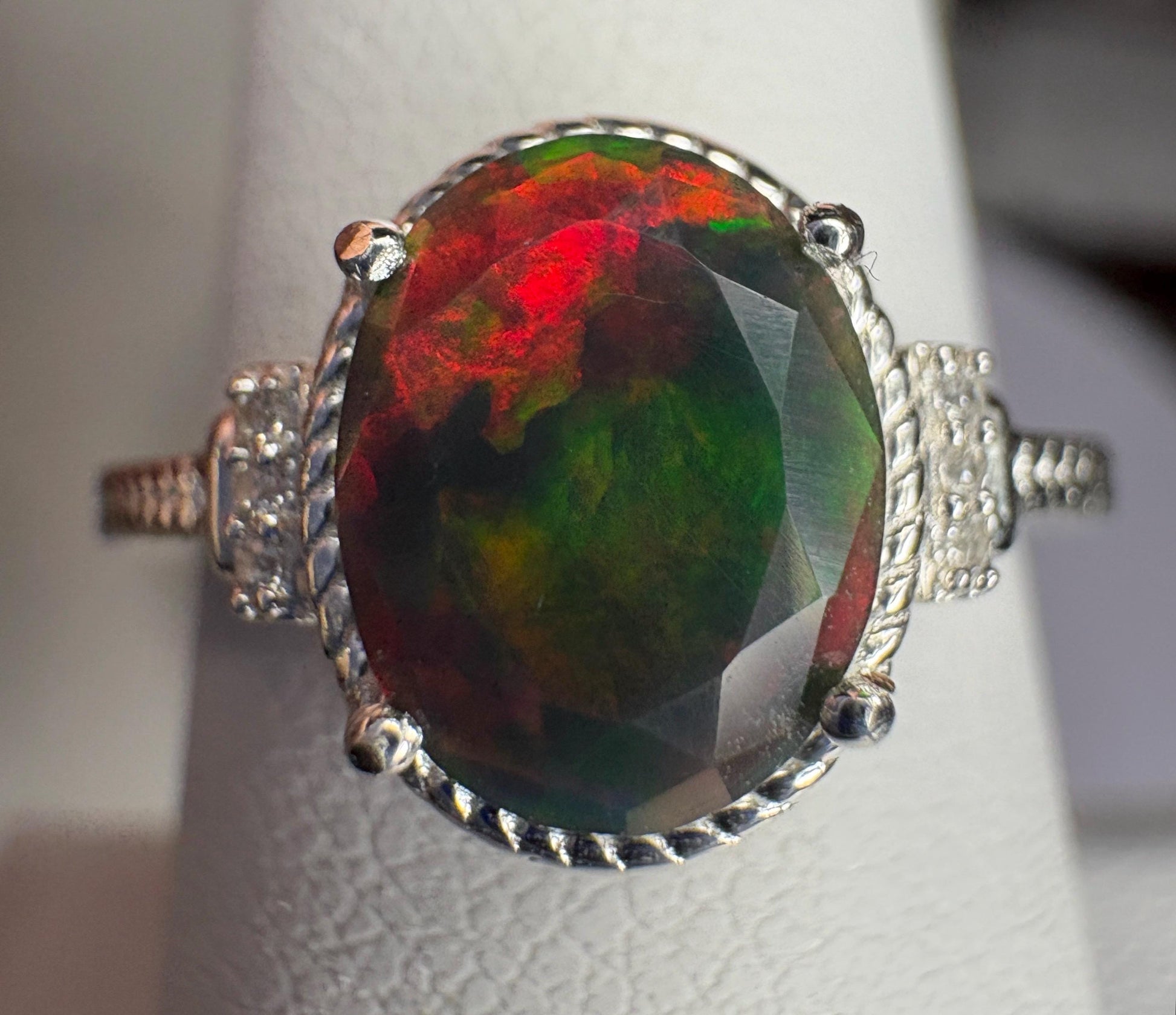 Oval Ethiopian black opal ring with red and green flashes in sterling silver.