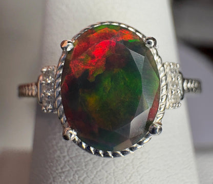 Oval Ethiopian black opal ring with red and green flashes in sterling silver.