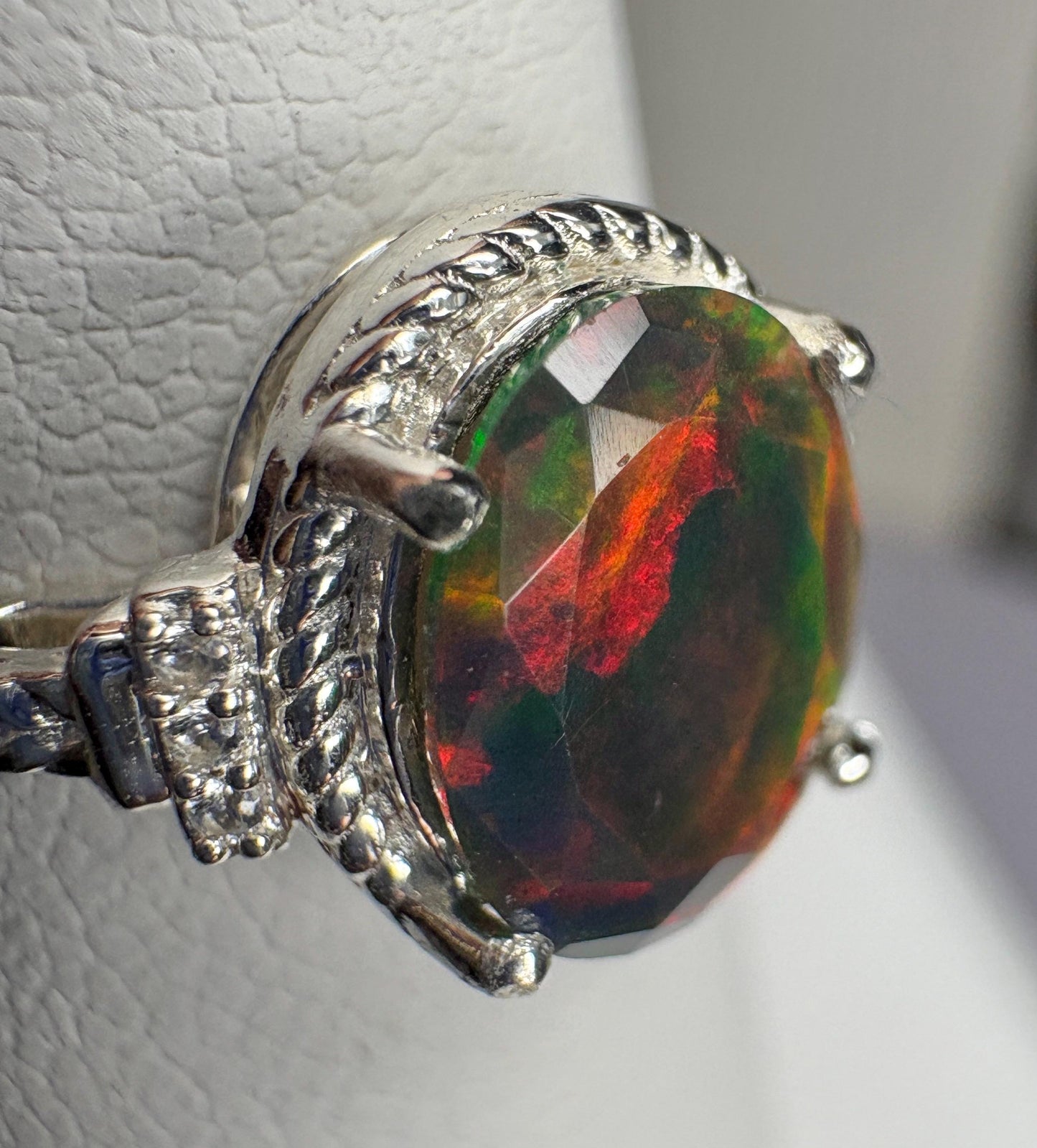 Sterling silver ring with a faceted Ethiopian black opal and braided detail.