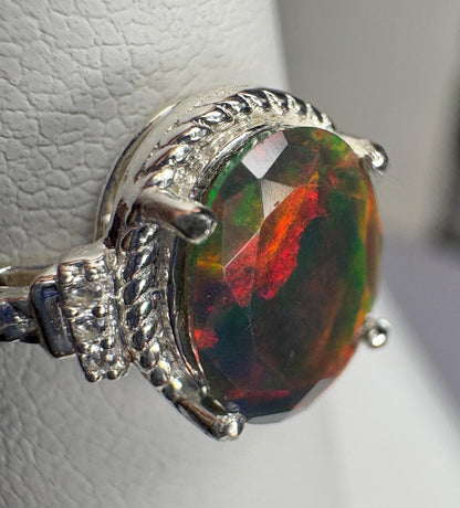 Sterling silver ring with a faceted Ethiopian black opal and braided detail.