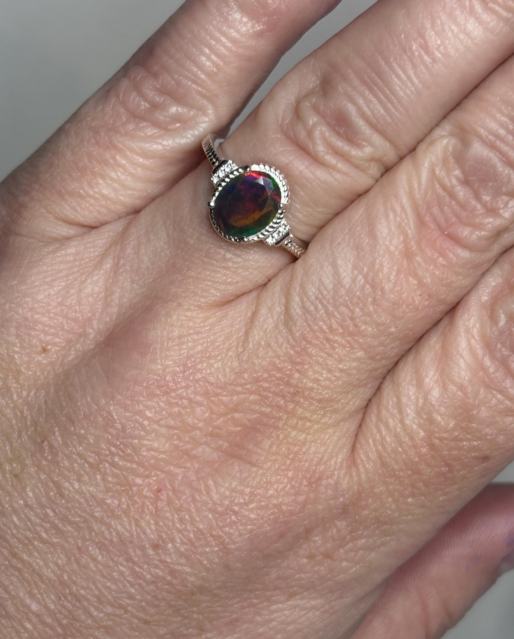 Sterling silver ring with an oval Ethiopian black opal and zircons.
