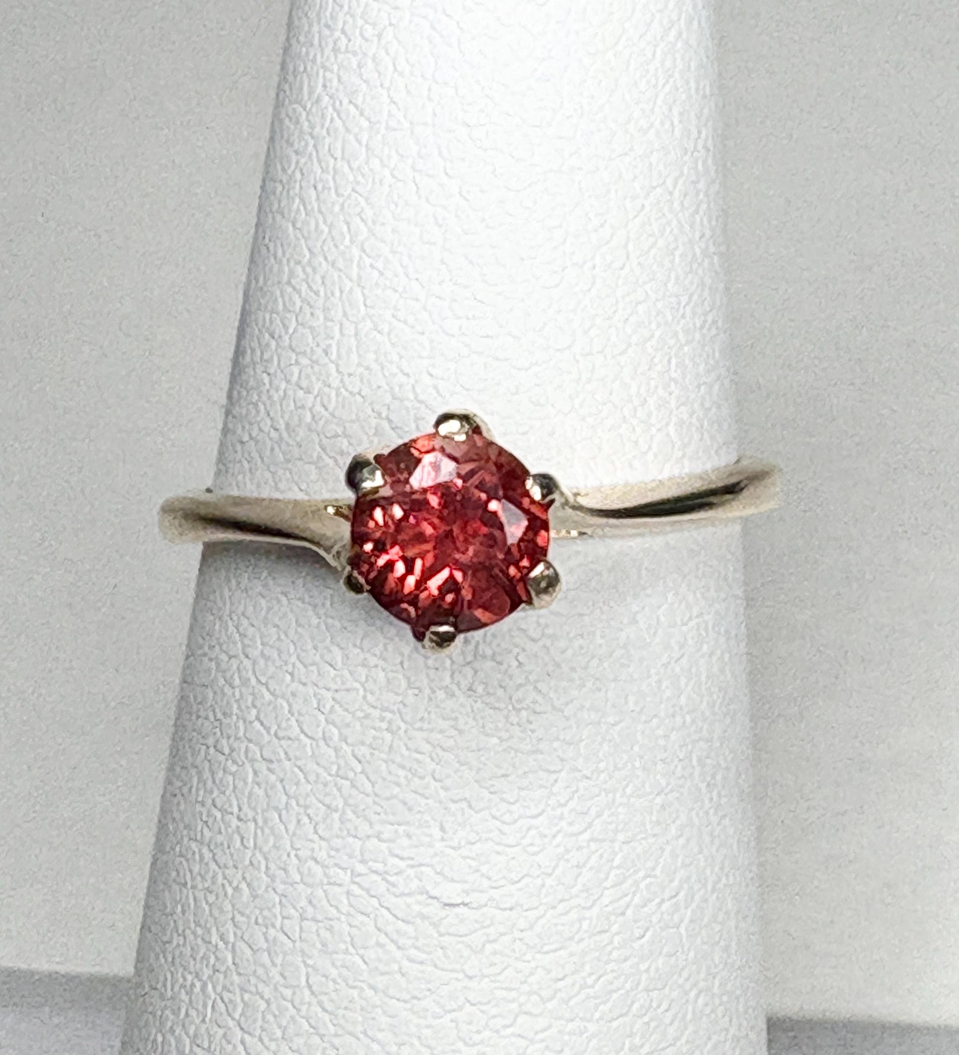 A red Oregon sunstone solitaire ring in 10k gold.