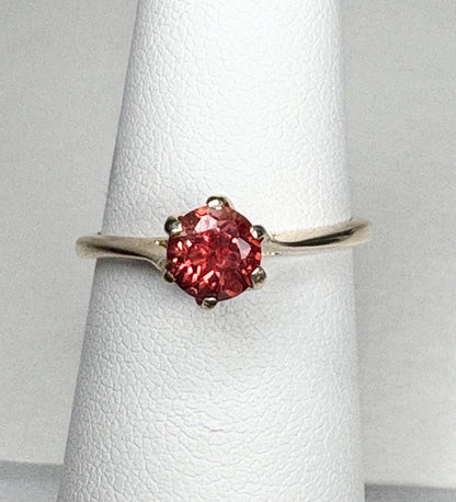 A red Oregon sunstone solitaire ring in 10k gold.