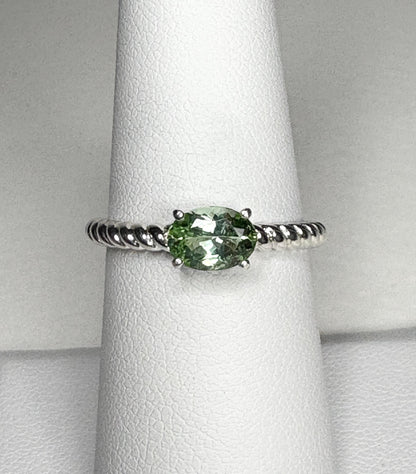 Sterling silver ring with an oval green tourmaline gemstone set east-west on a rope band.
