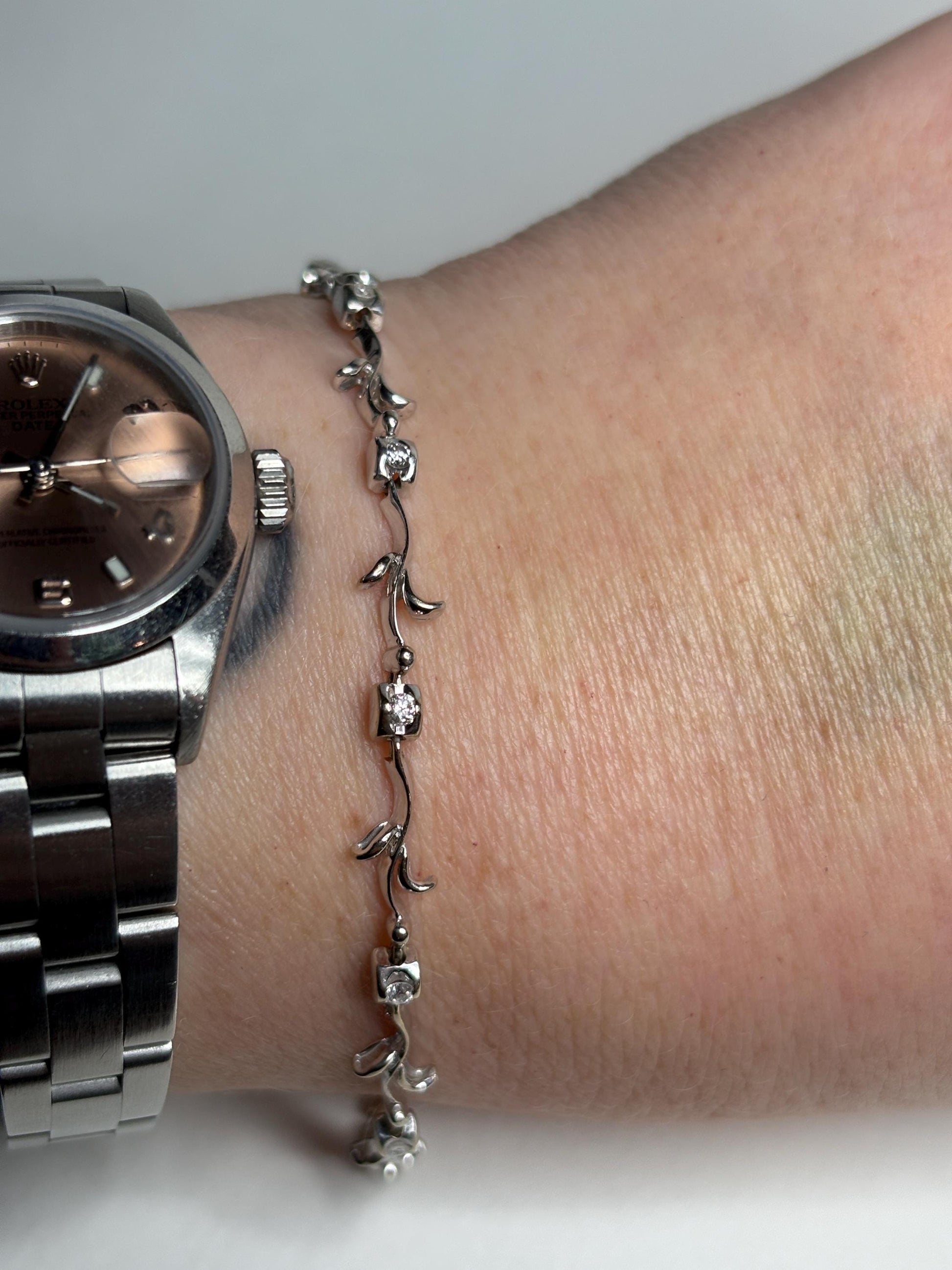 Solid 18k white gold bracelet with eleven natural diamonds in a vine link design.