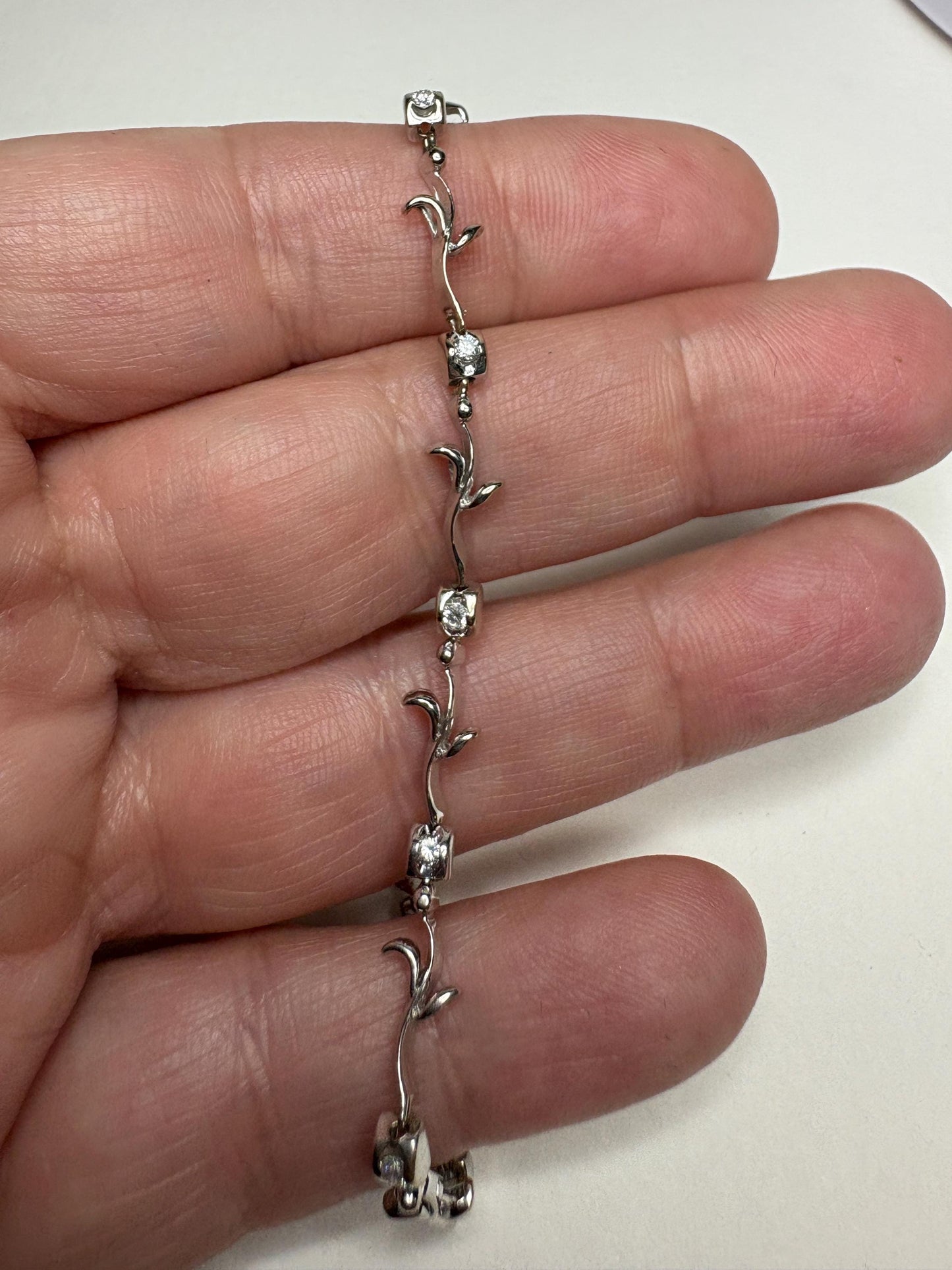 Solid 18k white gold bracelet with natural diamonds in a vine link design.