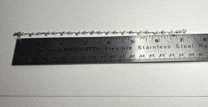 18k white gold bracelet with natural diamonds and vine links, measuring 7.25 inches.