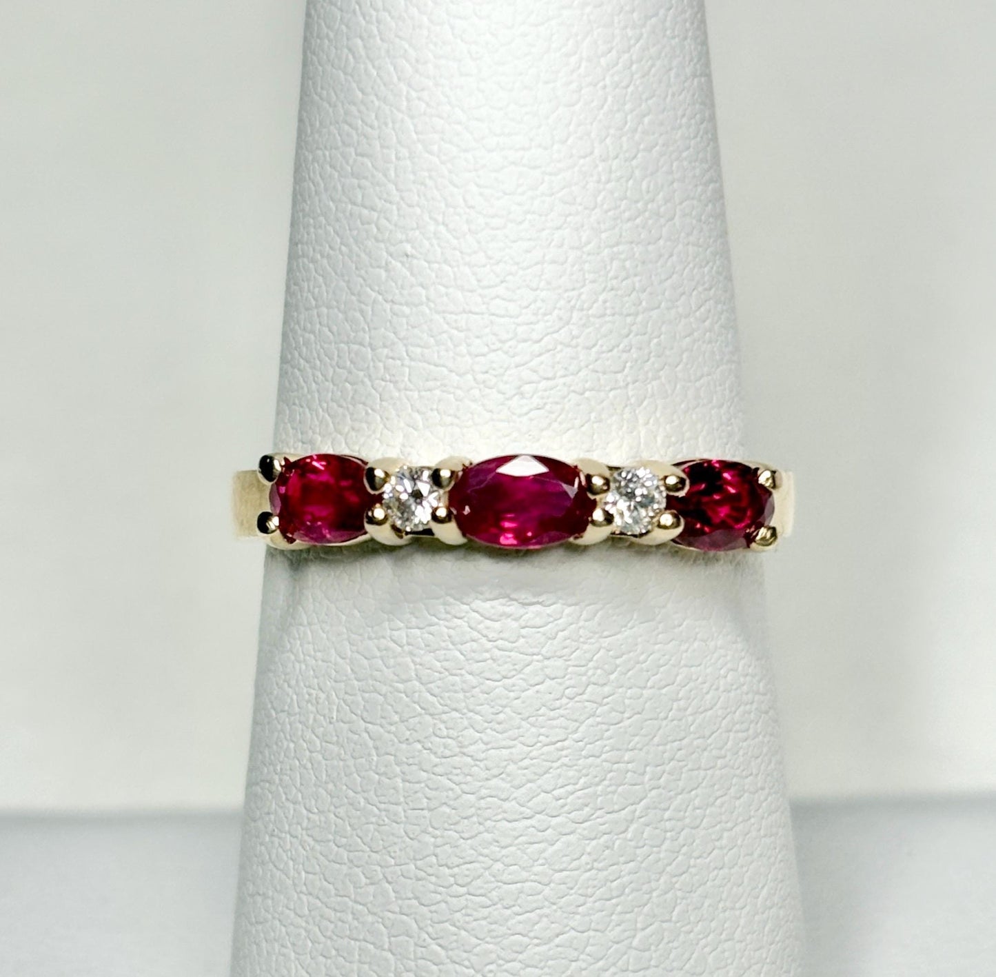 14k gold band ring with oval rubies and diamonds.