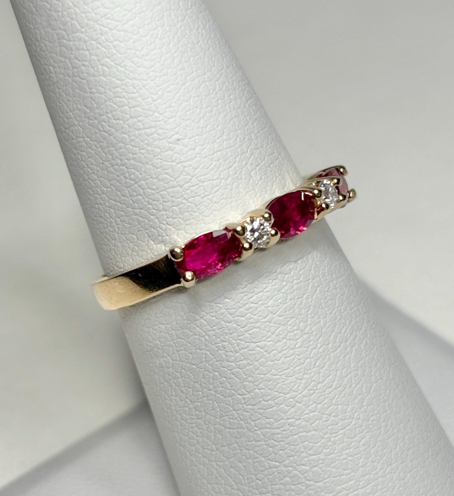14k gold band ring with oval red sapphires and diamonds.