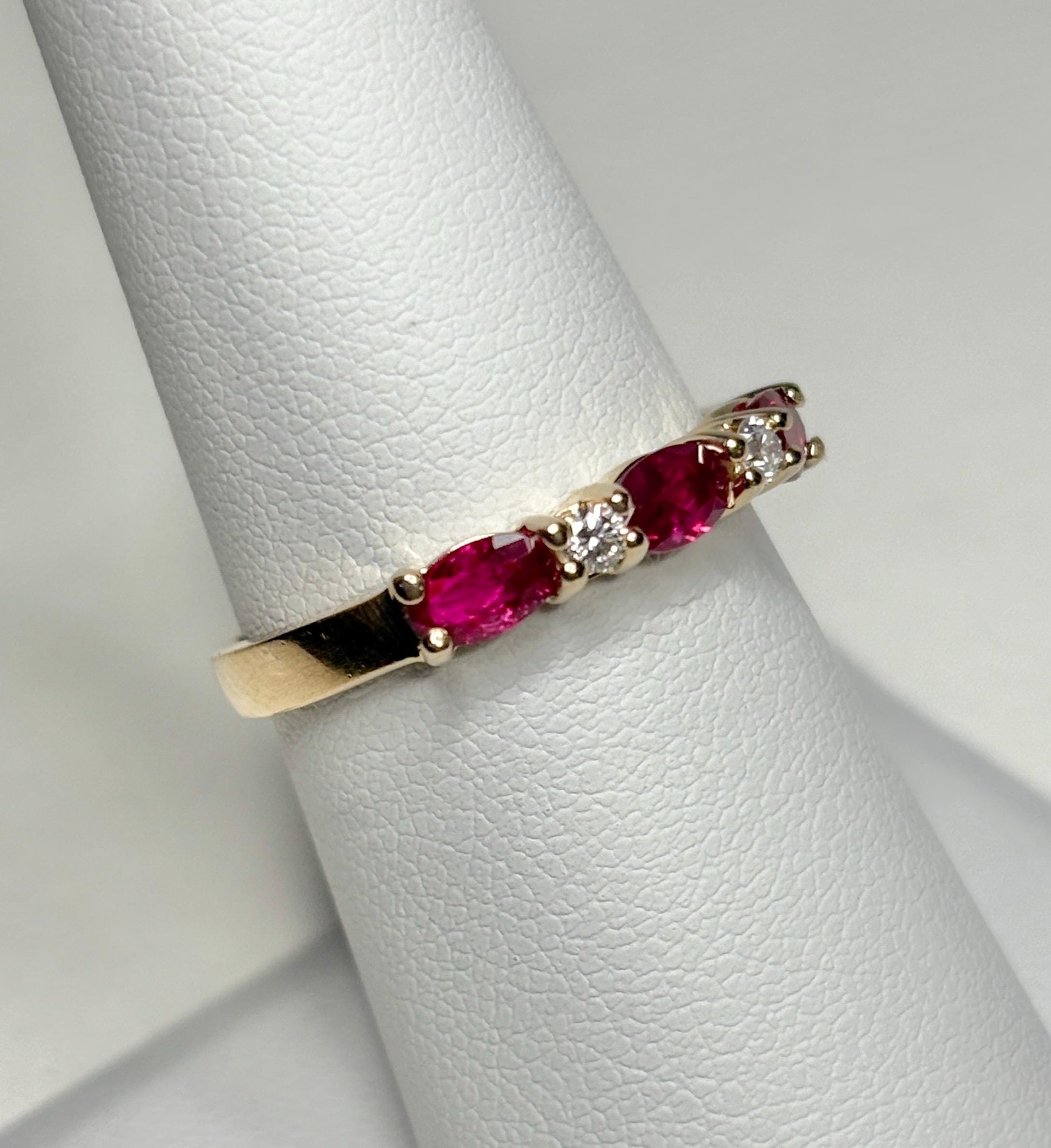 14k gold band ring with oval red sapphires and diamonds.