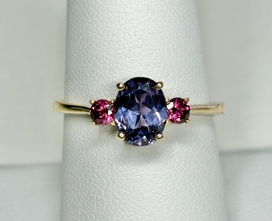 10k gold ring with a color-changing synthetic sapphire and two umbalite garnets.
