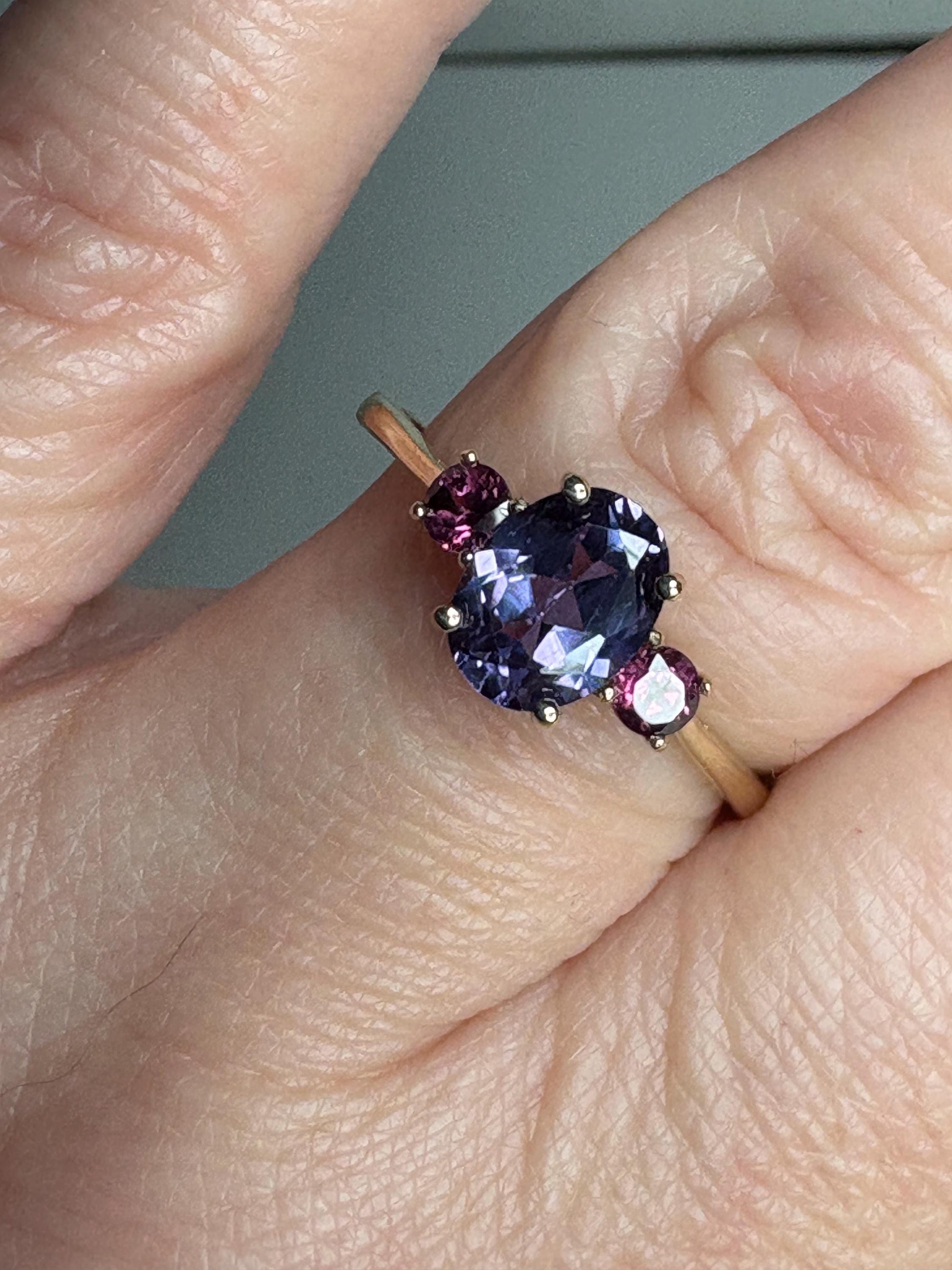 Color change synthetic sapphire and umbalite garnet ring in 10k gold.