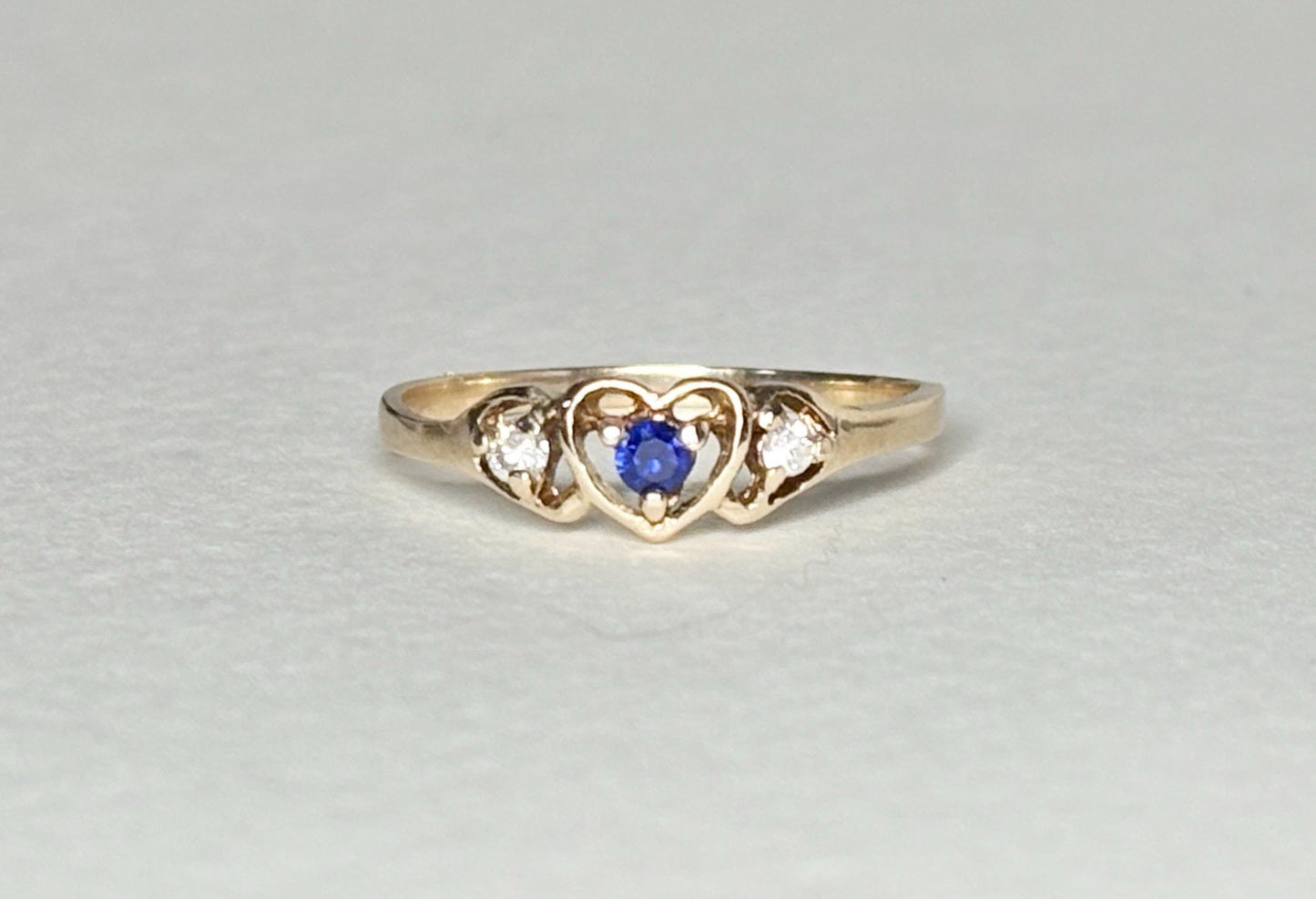 10k gold heart ring with blue sapphire and diamonds.