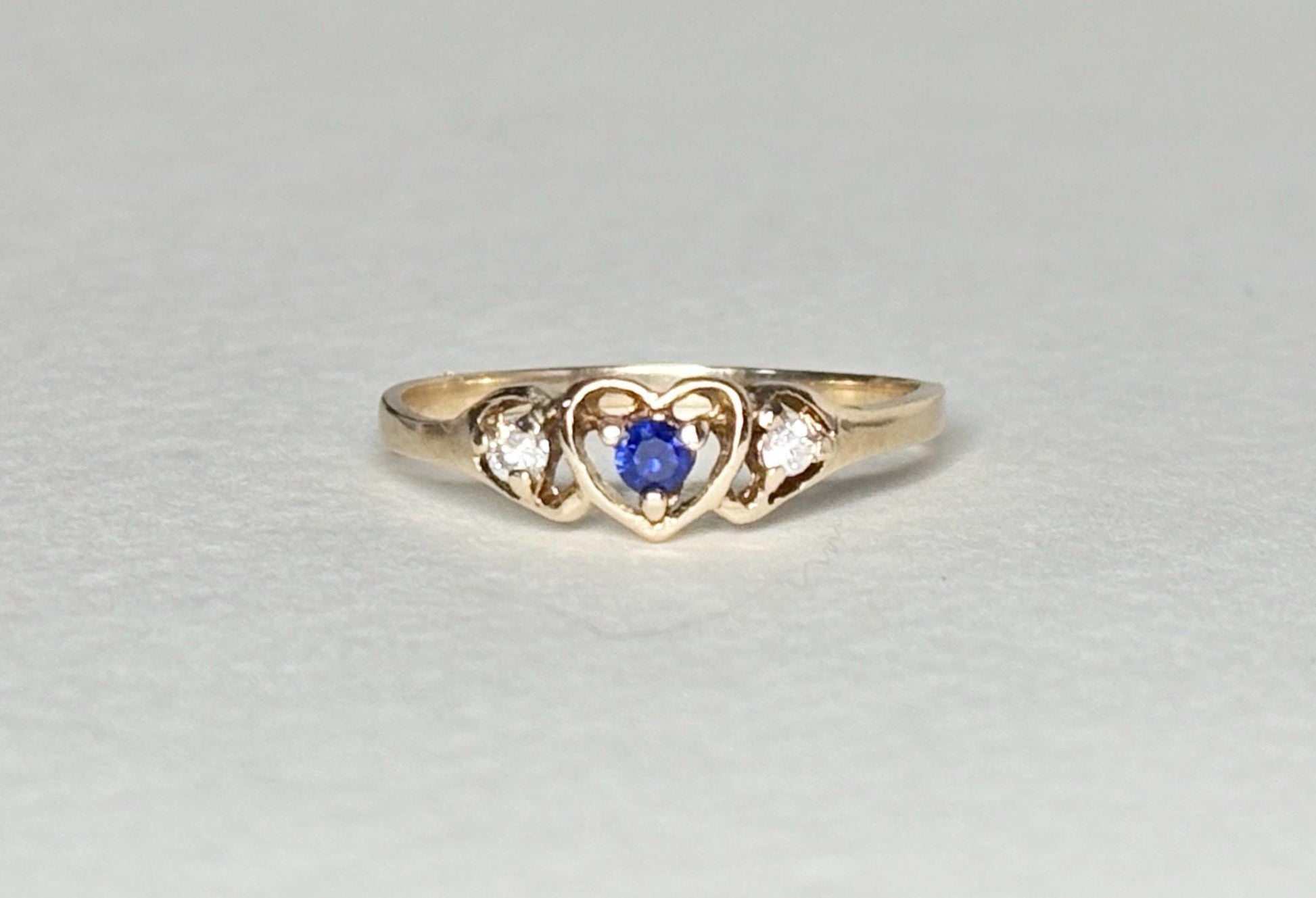 10k gold heart ring with blue sapphire and diamonds.