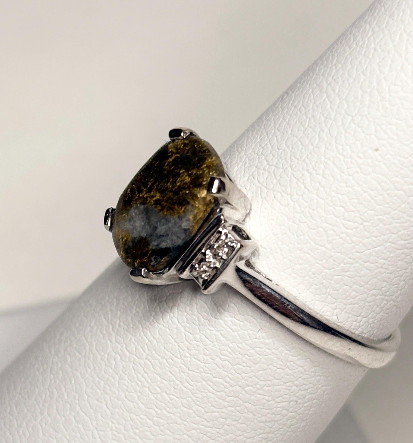 A pear-shaped gold in quartz ring with diamonds set in 10k white gold.