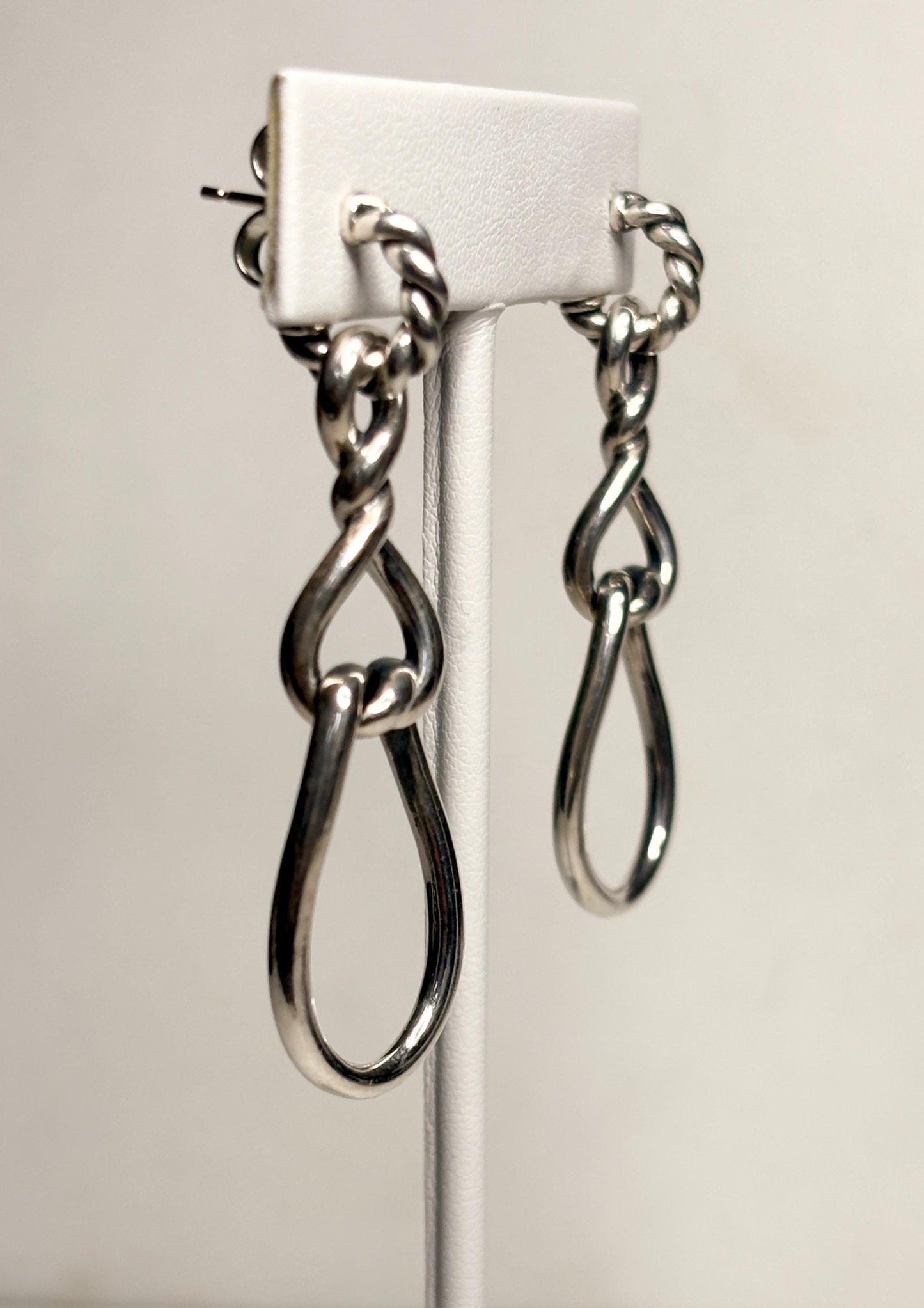 Sterling silver dangle hoop earrings with twisted rope detail and gold posts.