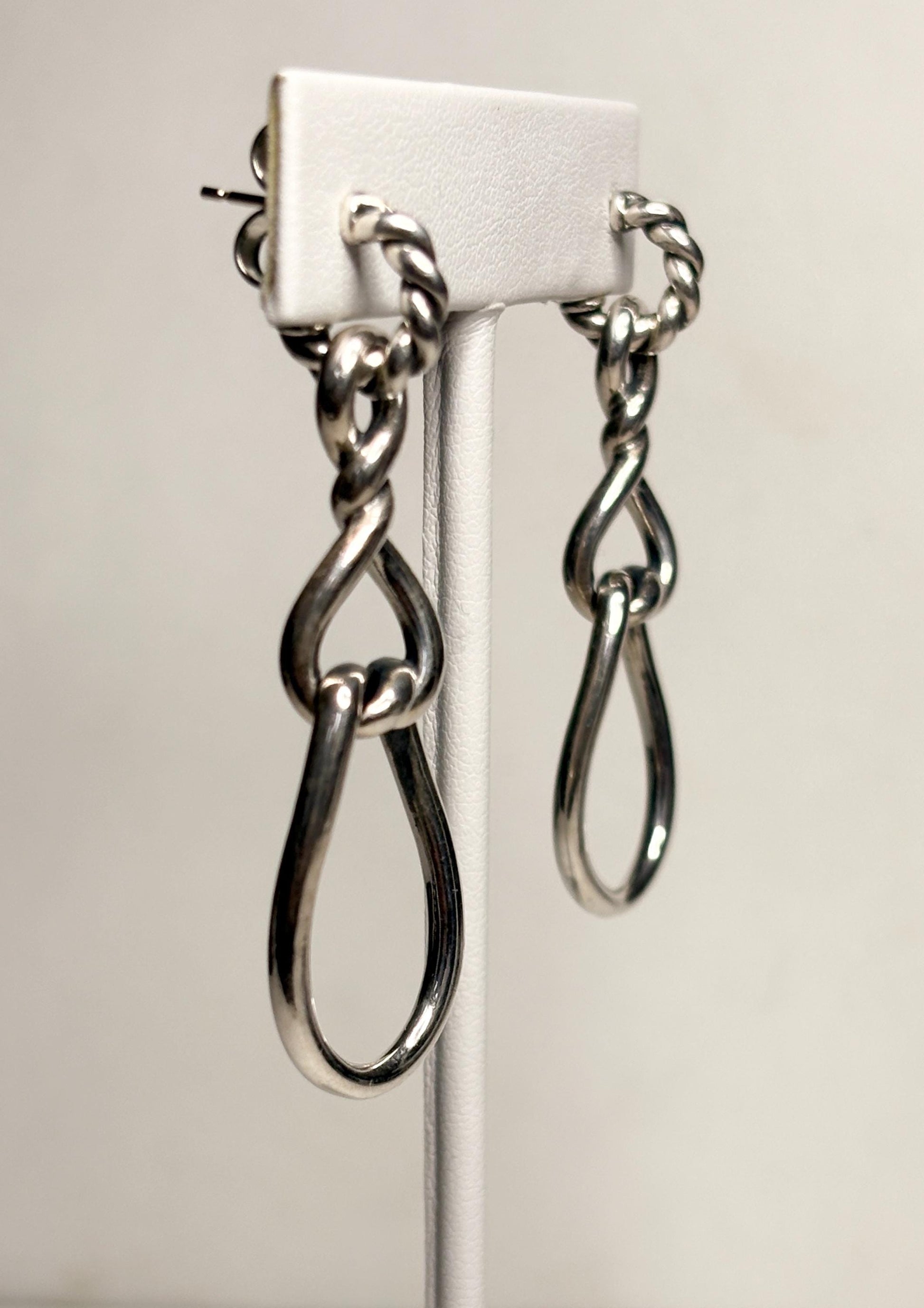 Sterling silver dangle hoop earrings with twisted rope detail and gold posts.