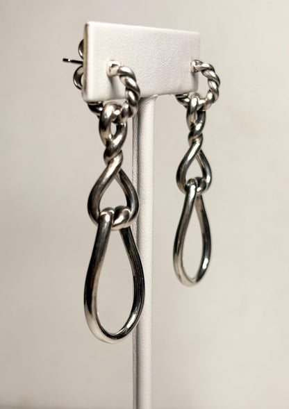 Sterling silver dangle hoop earrings with twisted rope detail and gold posts.