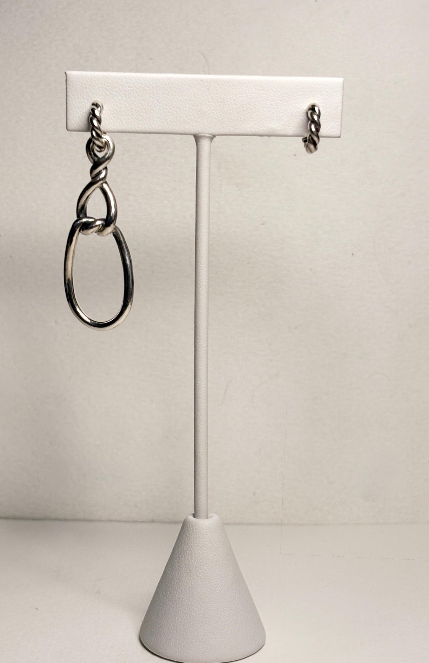 Sterling silver dangle earrings with twisted rope detail and oval drops.