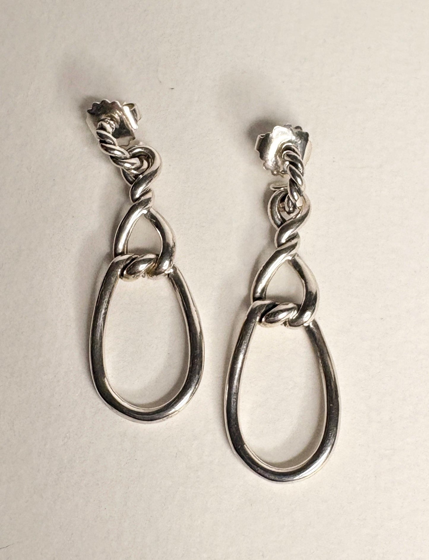 Sterling silver dangle earrings with twisted rope detail and 14k gold posts.