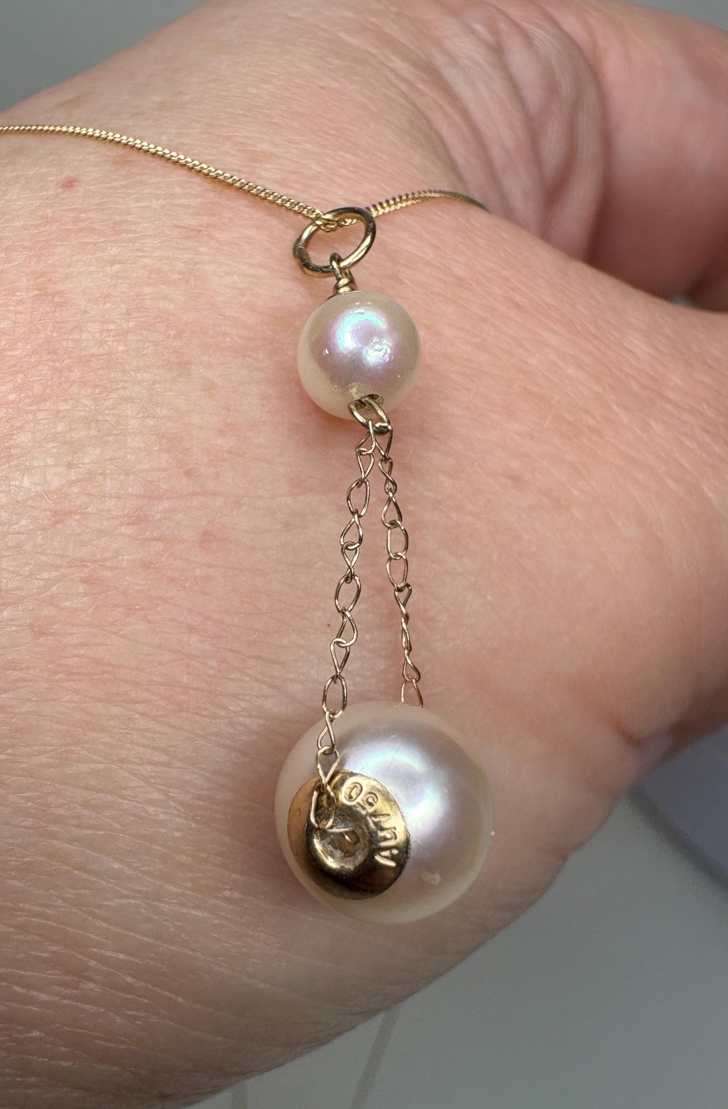 Akoya cultured pearl lavaliere pendant necklace with 18k gold end caps on 14k gold chain.