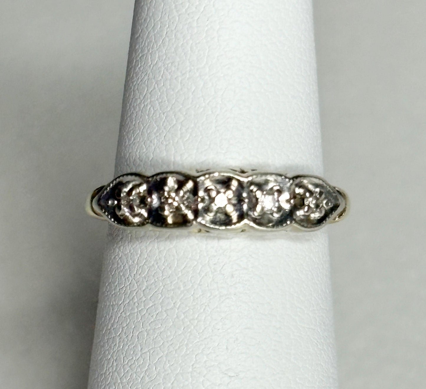 Vintage two-toned 10k gold band ring with five small diamonds.