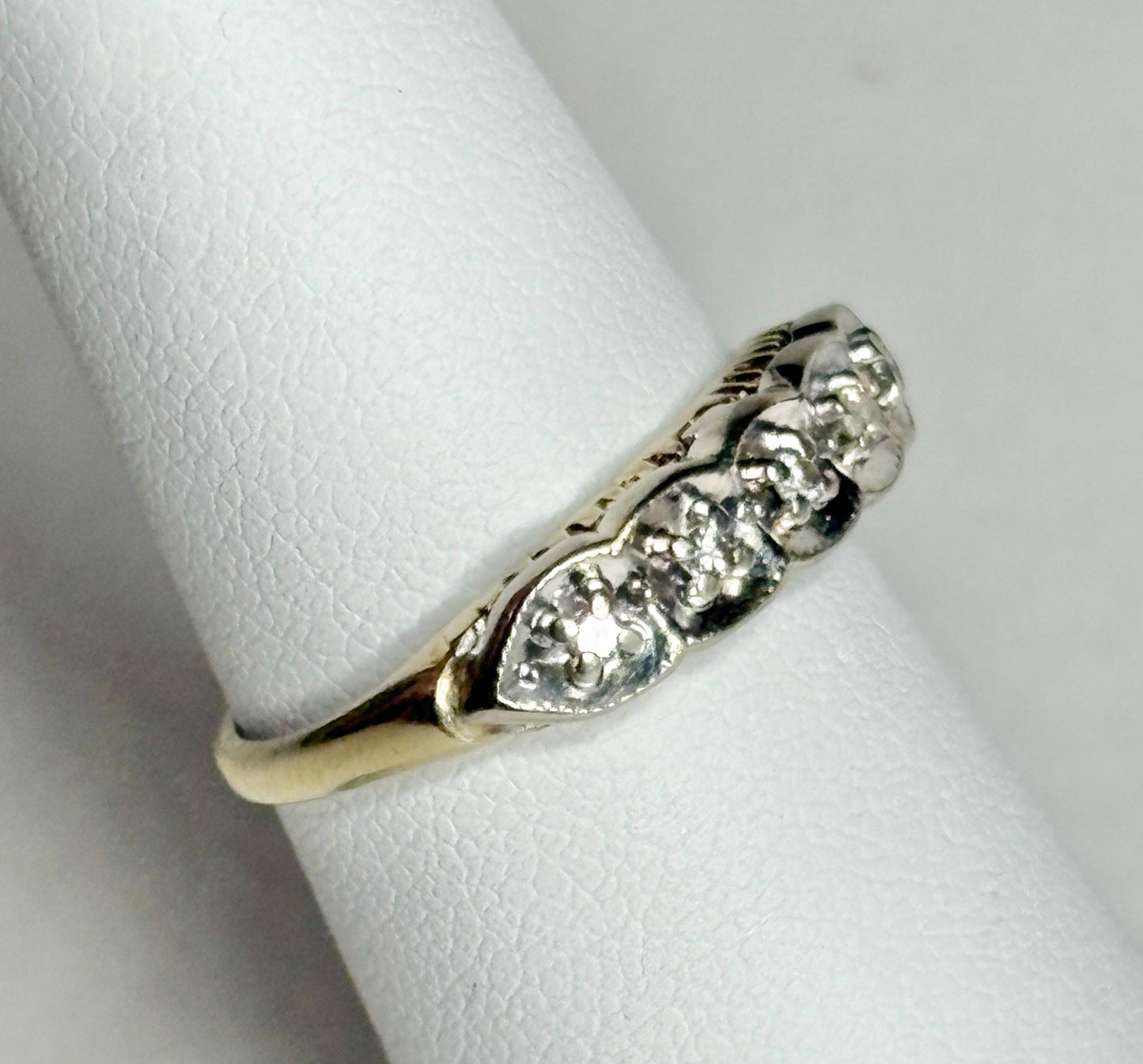 Vintage two-toned 10k gold band ring with five small diamonds.