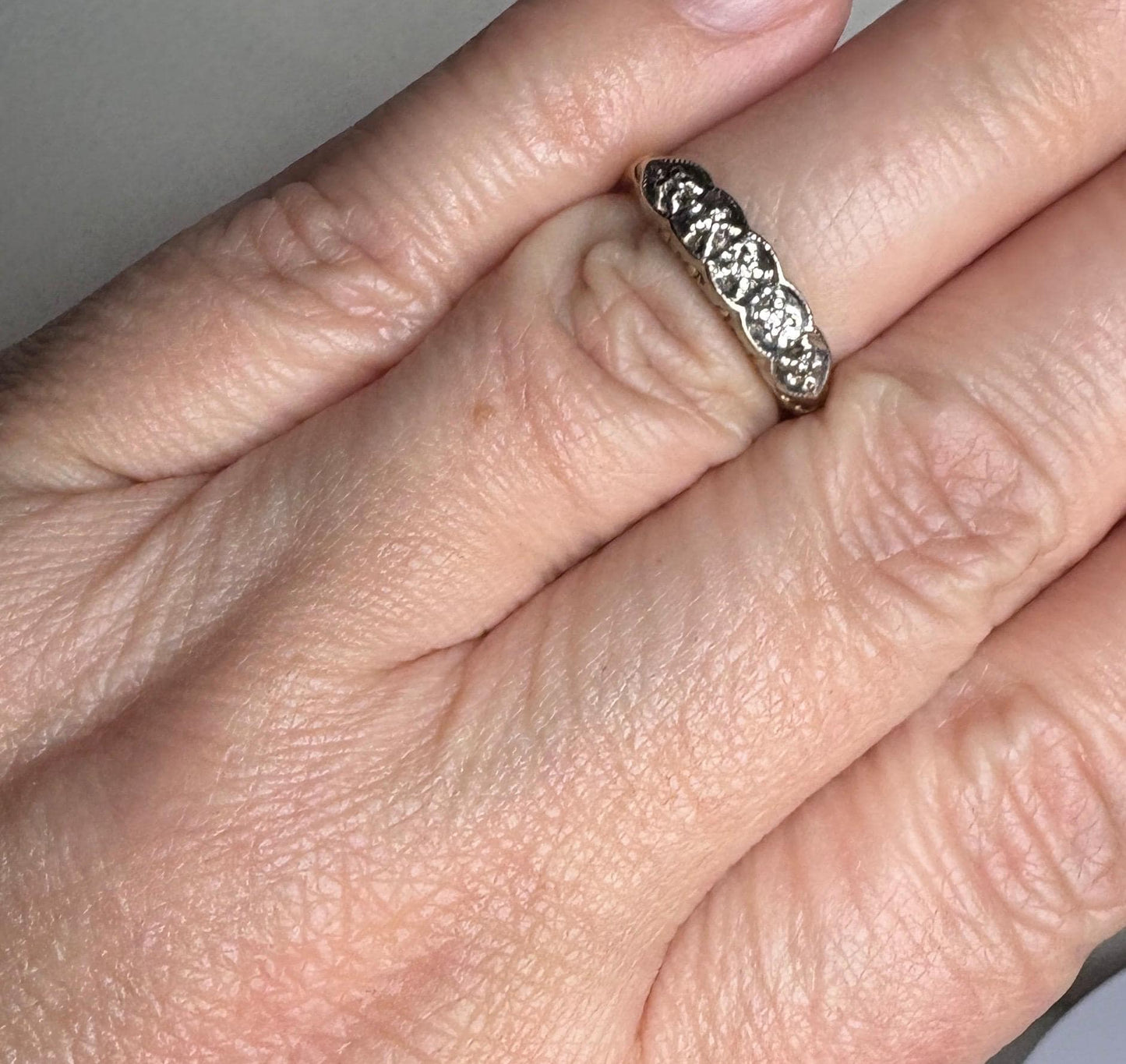 A vintage two-toned 10k gold band ring with small diamonds.