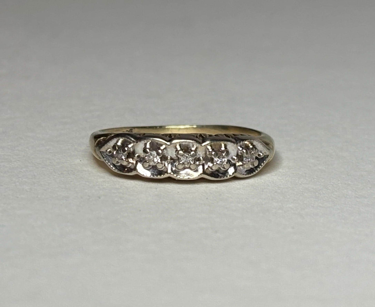 Vintage two-toned 10k gold band ring with five small diamonds.