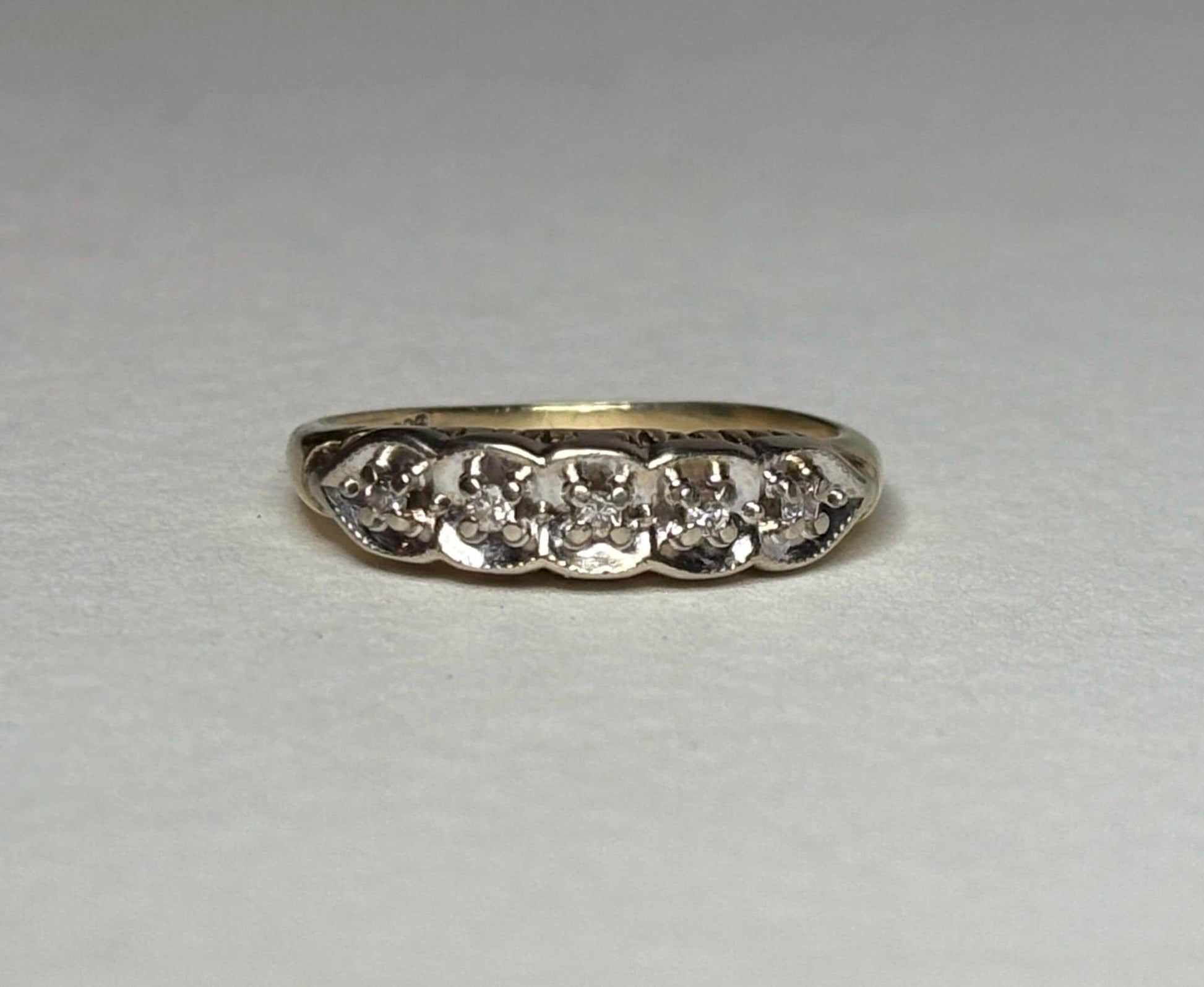 Vintage two-toned 10k gold band ring with five small diamonds.